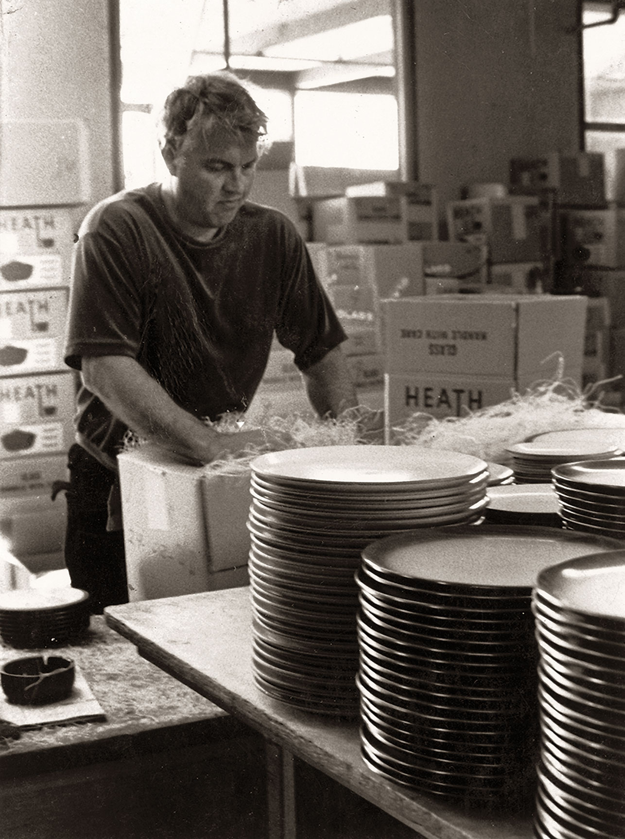 Man packing plates in Heath Ceramics factory