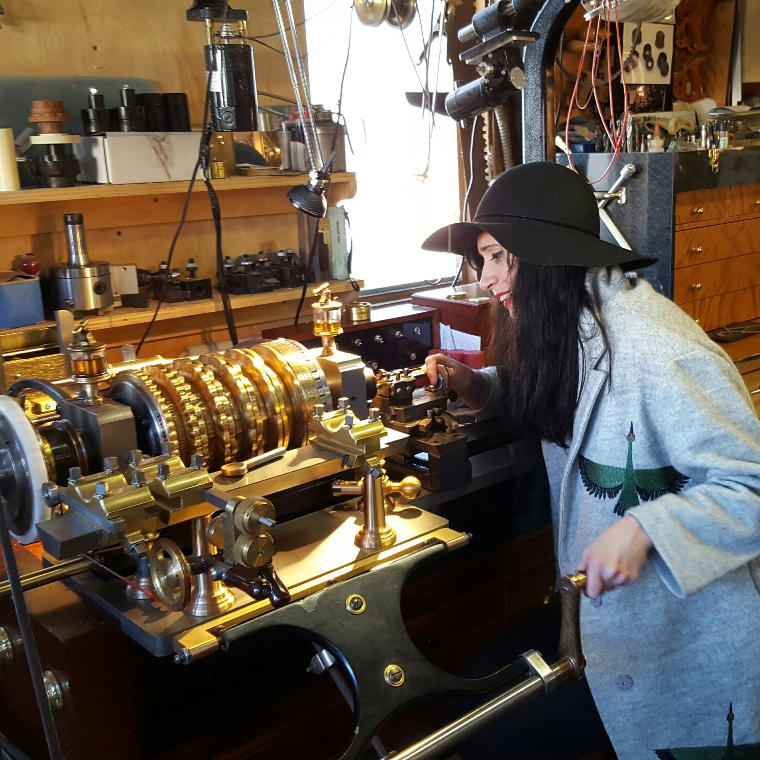 Brittany Nicole Cox working with a piece of antique machinery