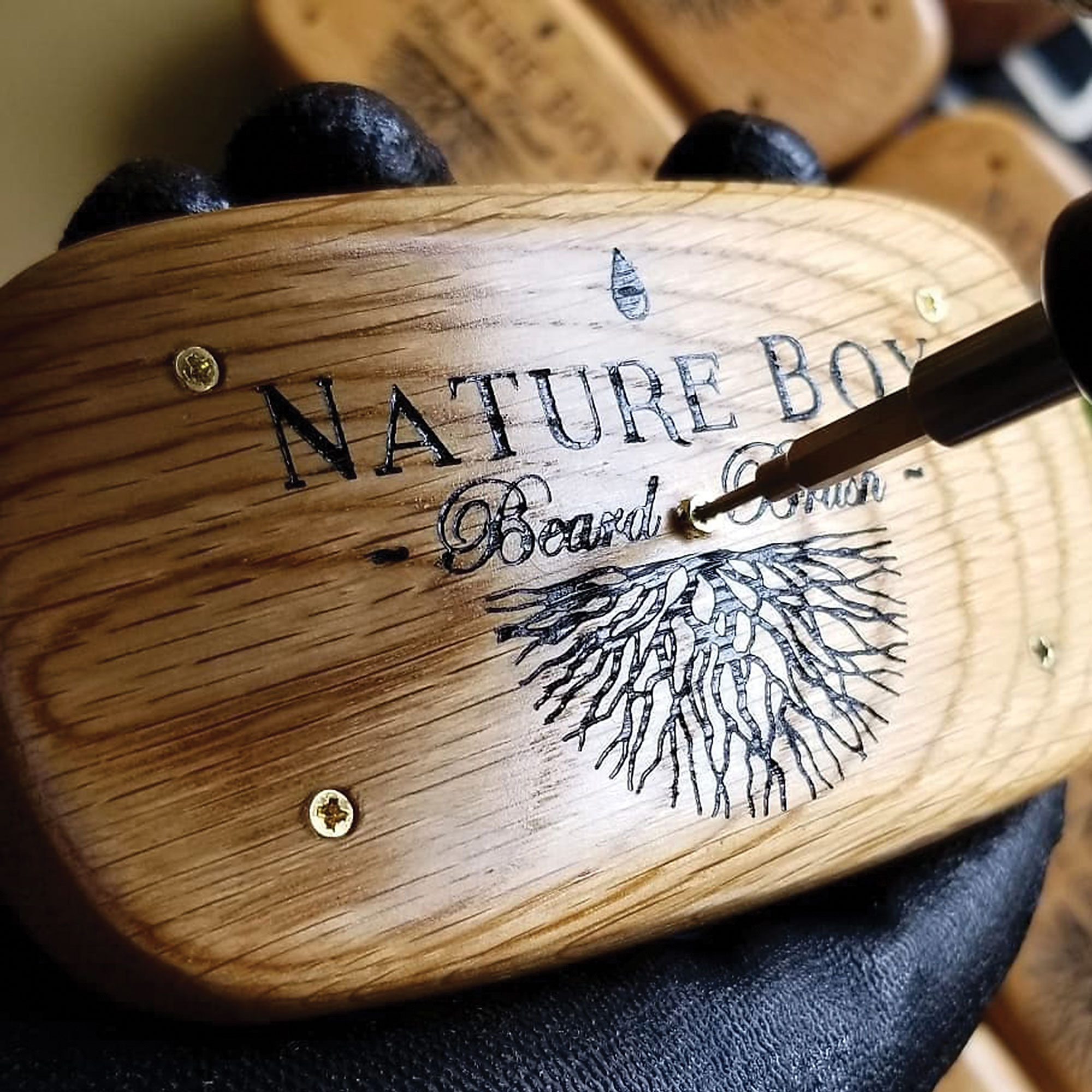 Screw being added to a Nature Boy brush