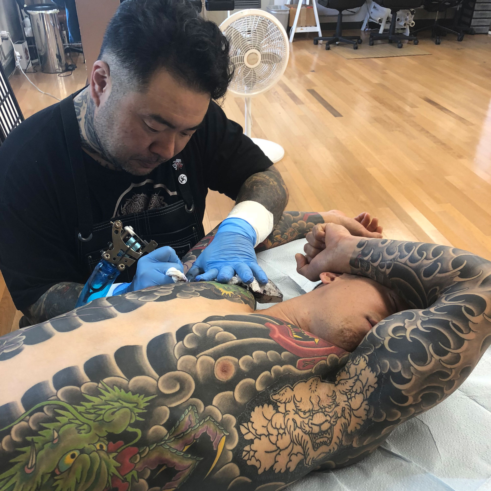 Takahiro Kitamura at work on a tattoo