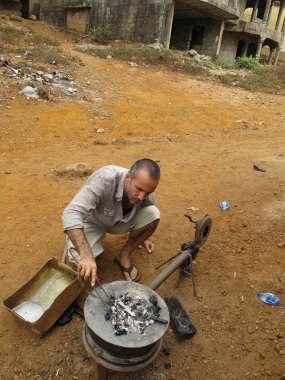Matthieu Cheminée in Guinea making a bracelet