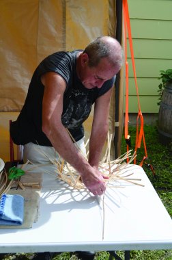 Pat Kruse works on a black ash hexagon weave basket at April Stone’s workshop
