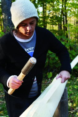 April Stone pounding a black ash log for basketmaking
