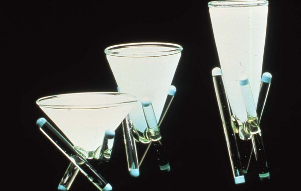 Three conical glass vessels with tripod legs