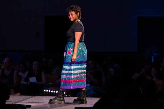 model showing a blue skirt with purple and pink horizontal ribbons