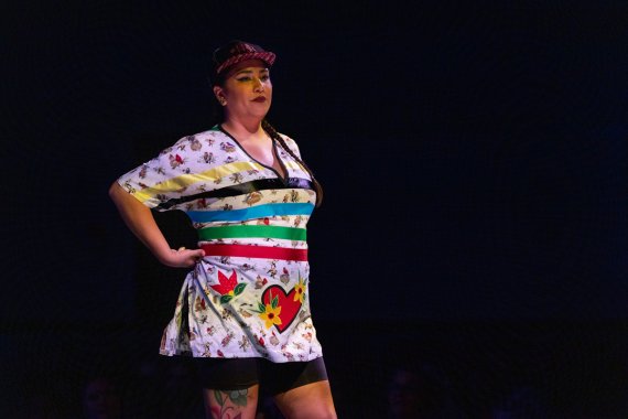 model showing a white shirt with bird print and various color ribbons and heart and flower applique