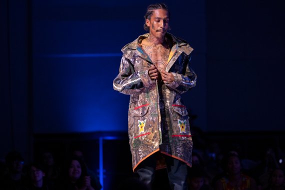 model showing a real tree camo jacket with flower applique and other red detailing