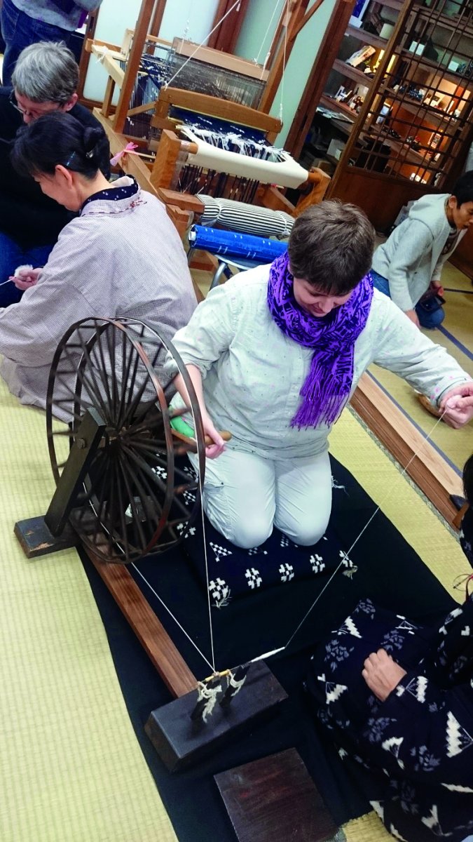 Saint Paul artist Paige Tighe spins cotton on a Japanese metal wheel.