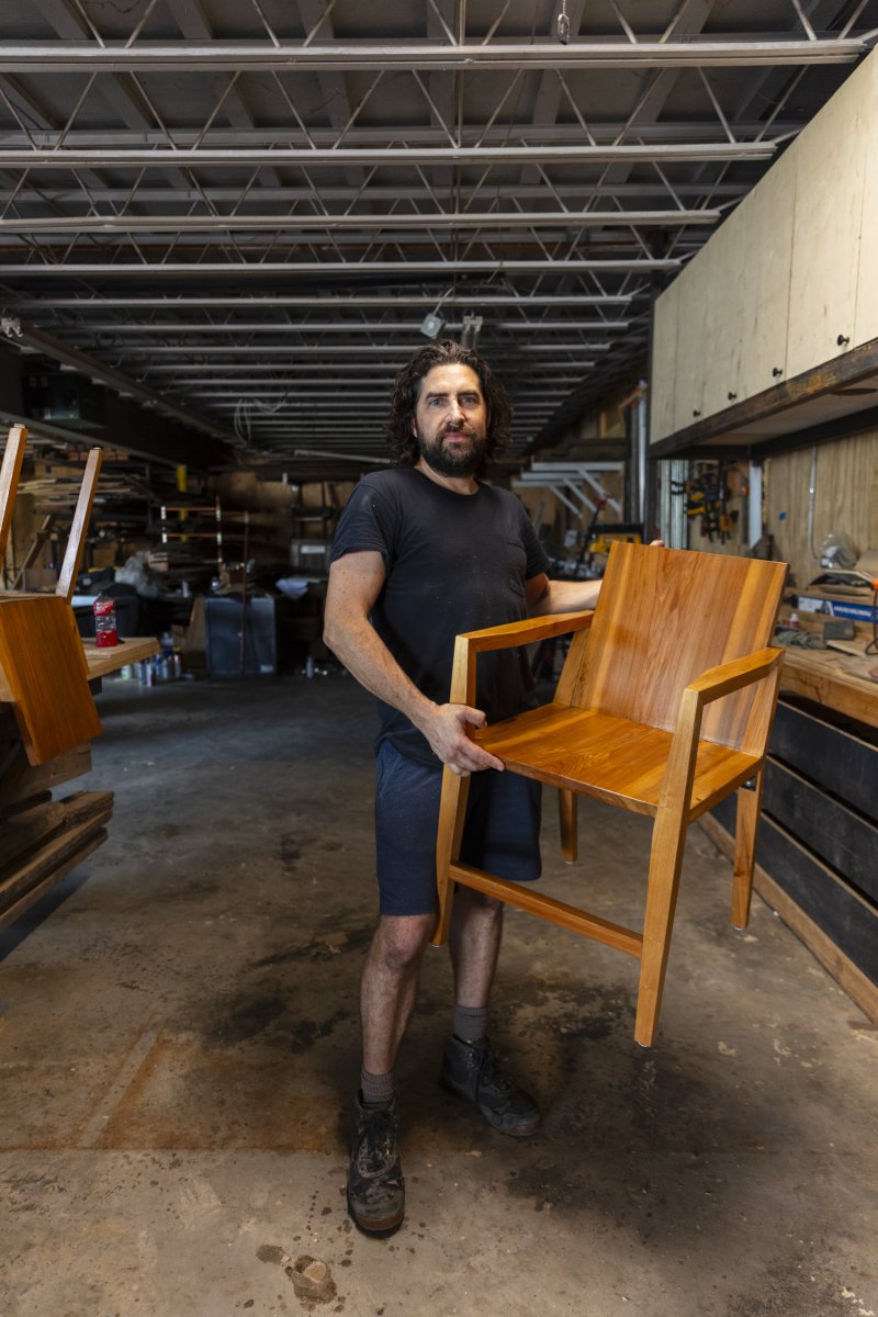 Holdren in his studio with a finished chair. Photo by Cedric Angeles.