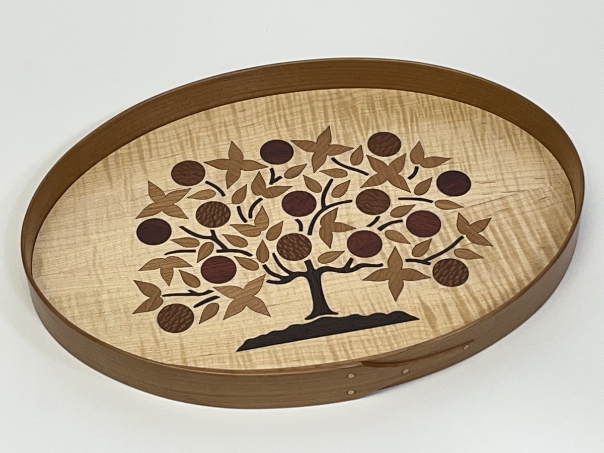 Jeff Neil’s Tree of Life Tray, 2023, cherry, curly maple, 1.25 x 12.75 x 9 in., is inlaid with various wood veneers in a design inspired by a painting made by a Shaker sister in 1854. Photo courtesy of the artist.