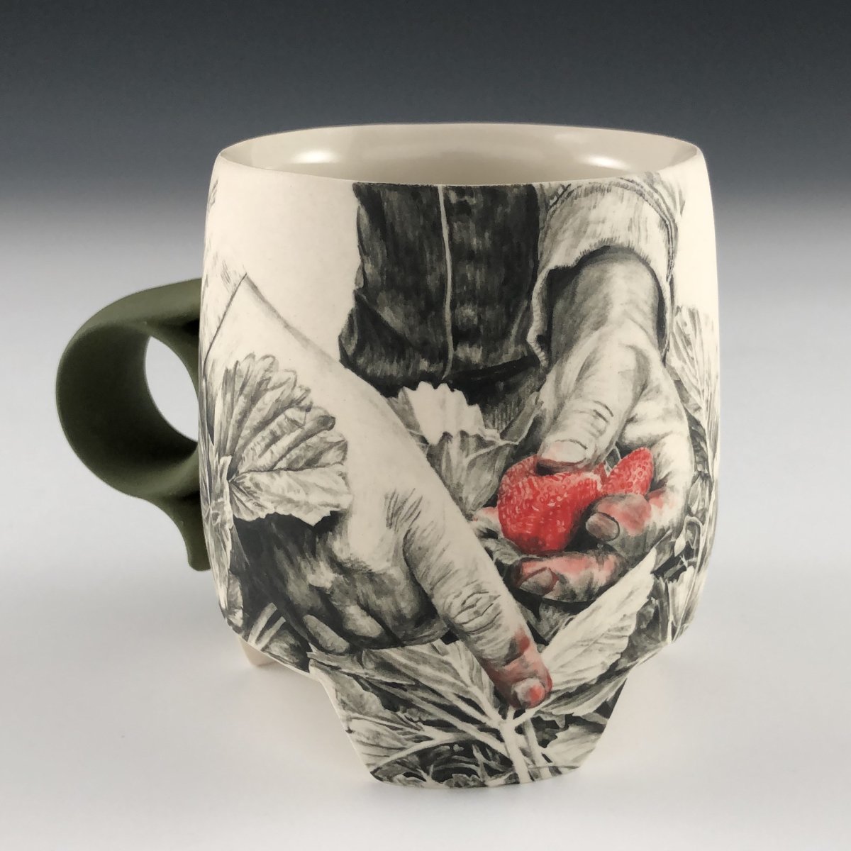 Hand-painted porcelain mug with hands holding a strawberry.