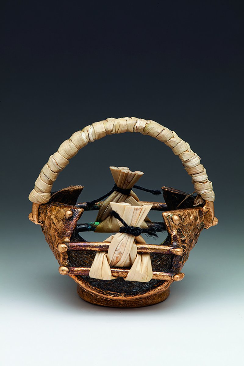 Small basket (1.375"x1.25"x1.25") made of bronze, woven sweetgrass and silk.