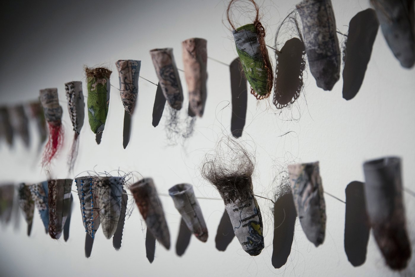Addressing abuses by the Catholic Church in Alaska, Sonya Kelliher-Combs’s installation Credible, Small Secrets, 2022, is made of glass beads, steel pins, cotton, human hair, and nylon. It will appear in Arctic Highways at the American Swedish Institute. Photo by Elisabeth Ohlson. 