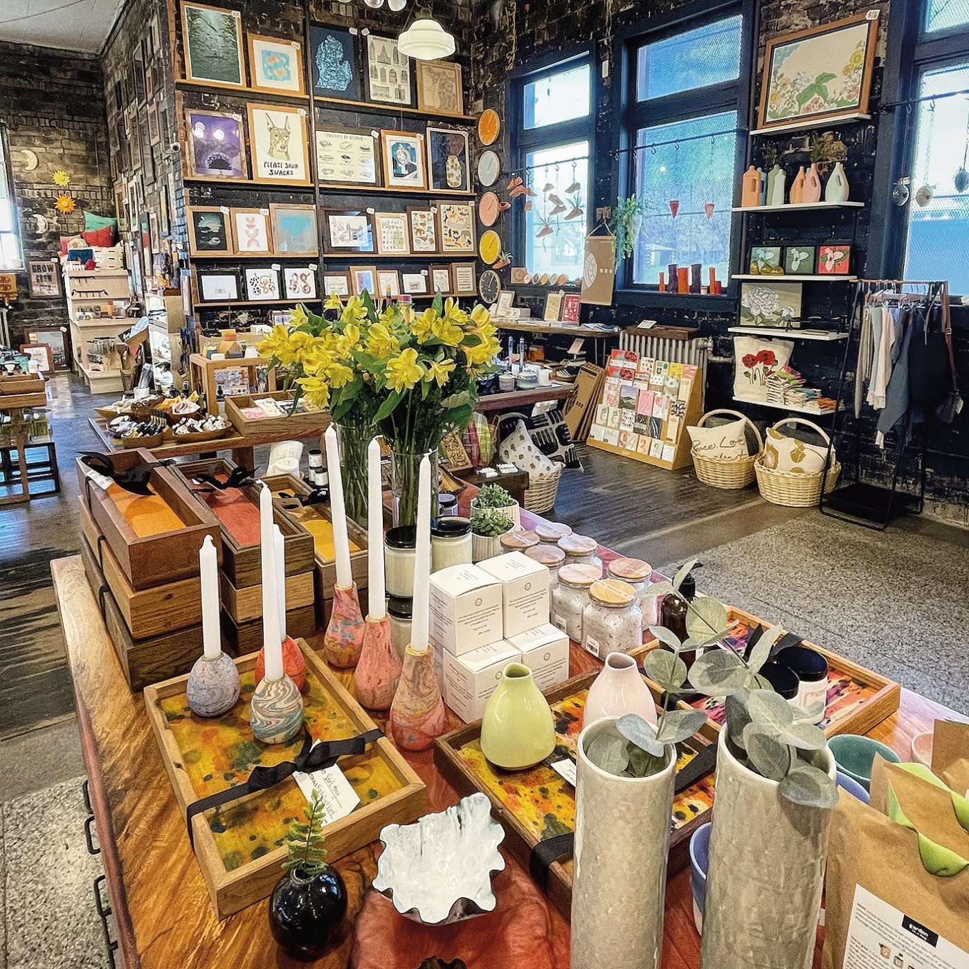 Inside image of POST's shop featuring marbled wood candleholders, hand-dyed valet trays, ceramics, bath and body products.