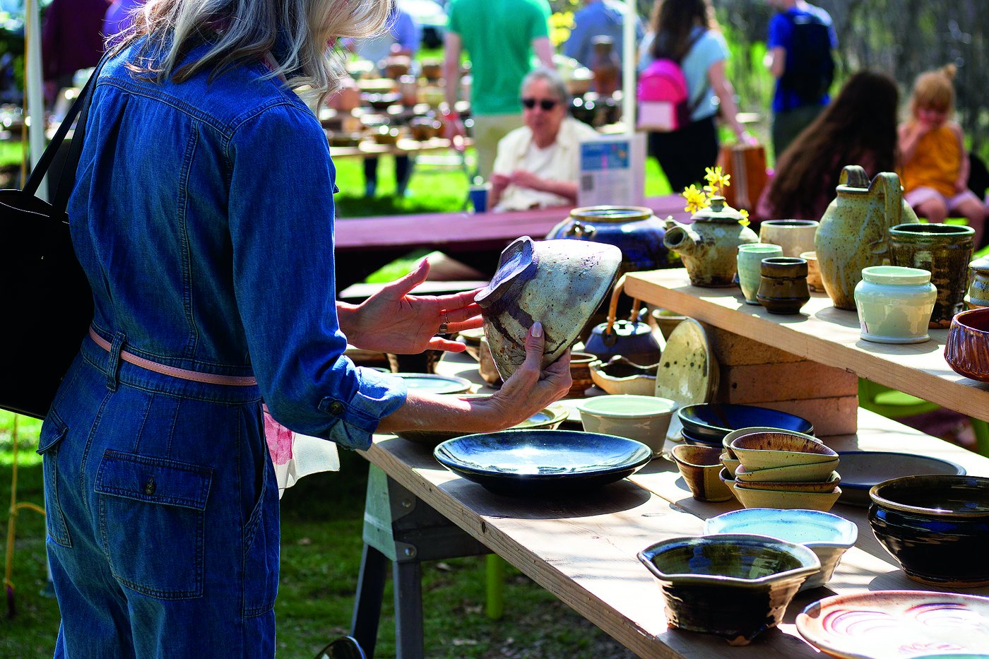 Image of a customer holding pottery. 