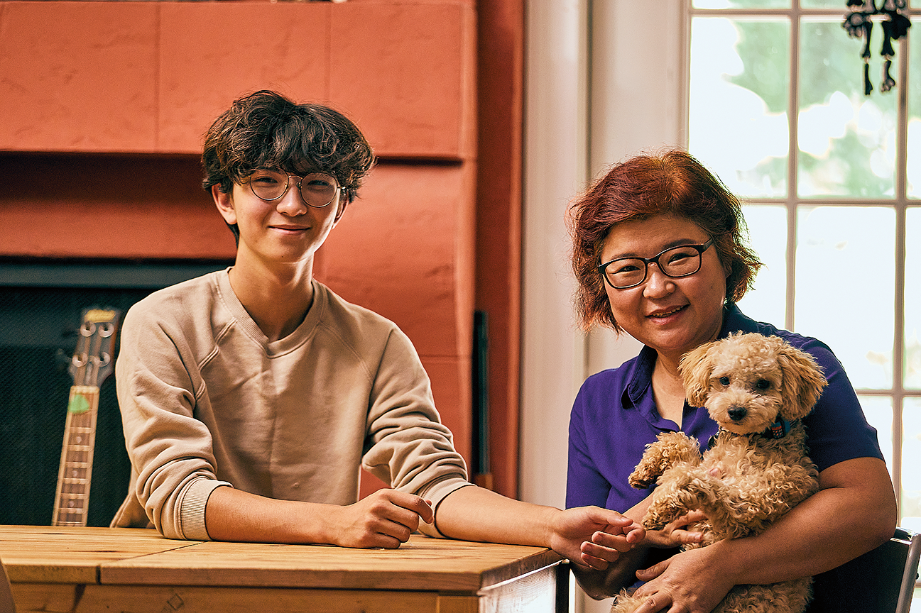 The artist upstairs in her home with her son, Oliver Moon Wilson, and their poodle, Miso Moon Wilson.