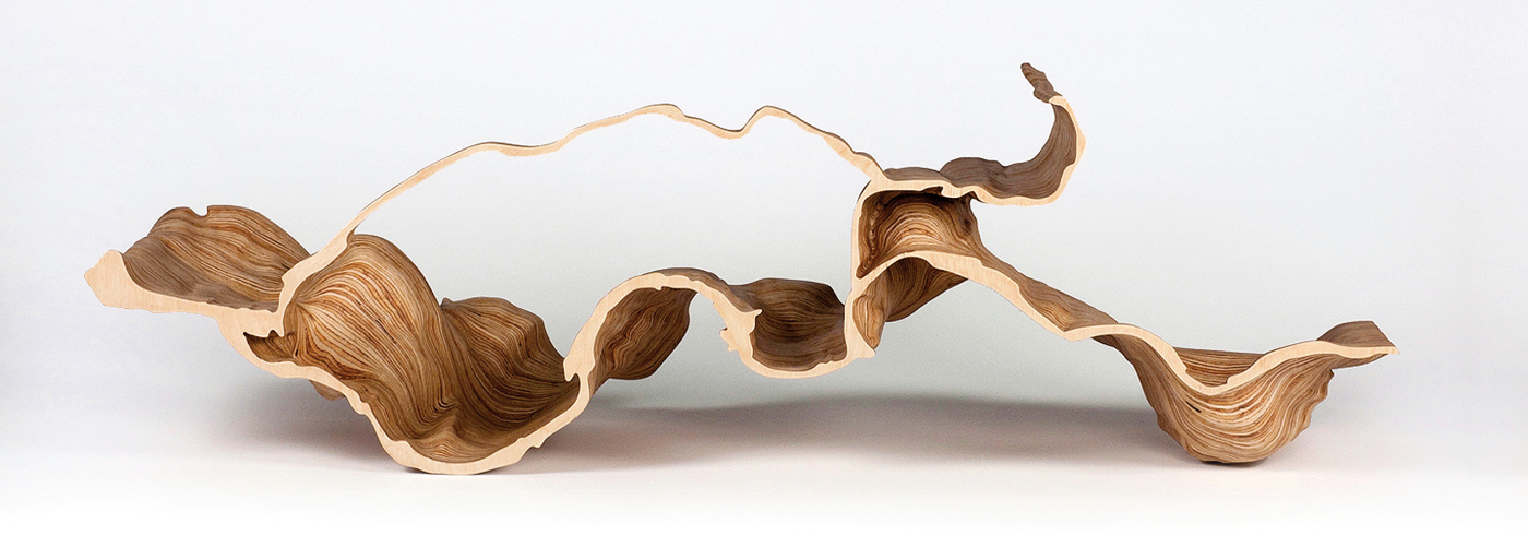 Adrien Segal’s carved plywood Molalla River Meander, 2013, shows changes in alluvial flows in the Oregon river over 15 years, 15 x 46 x 11 in. Photo by Adrien Segal.