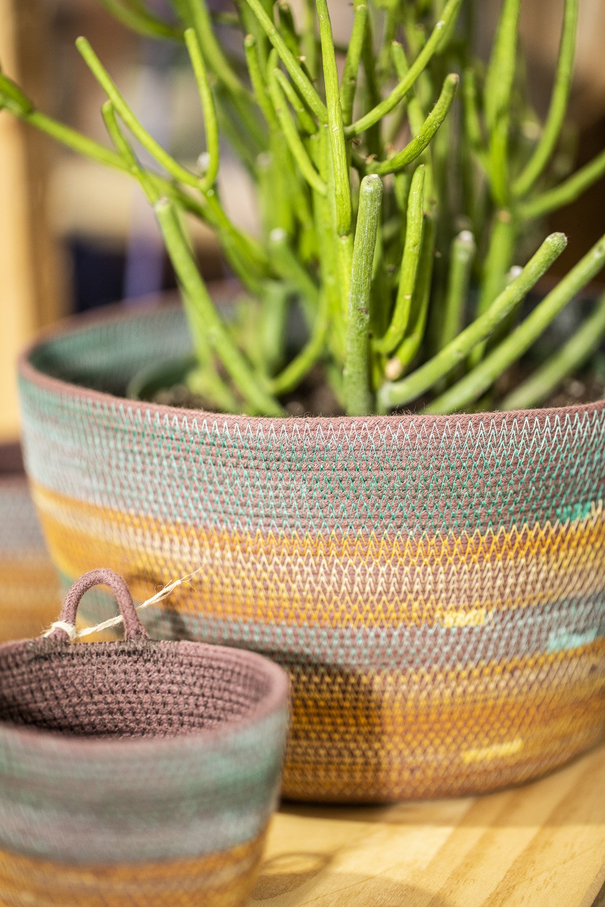 Multiple sizes of colorful baskets made of hand-dyed robes and fibers. 