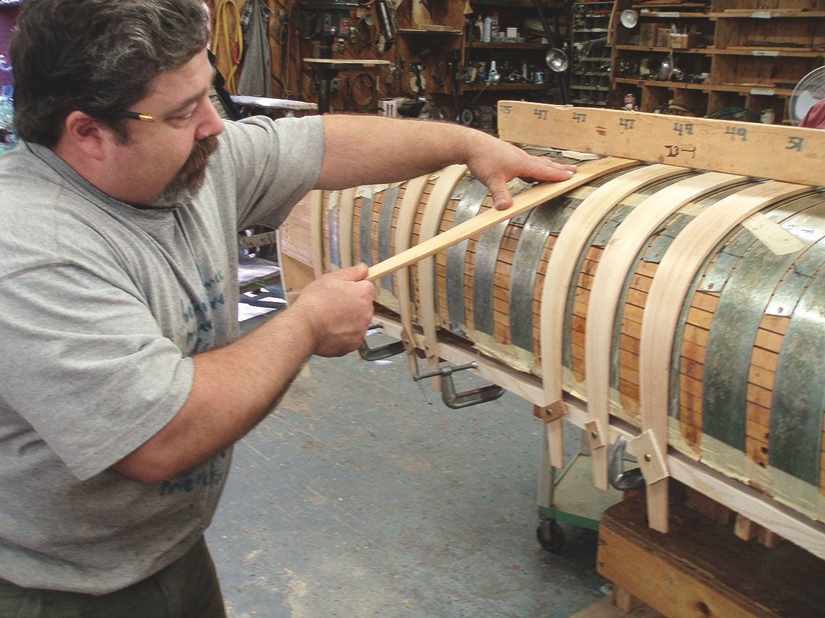 White cedar ribs being bent over the canoe form.