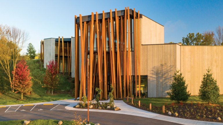 Contemporary art museum exterior with facade of leaning wooden columns