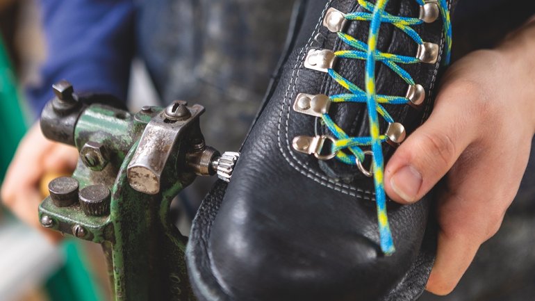 Emmett Moberly-LaChance presses the midsole layer to the upper of the boot.