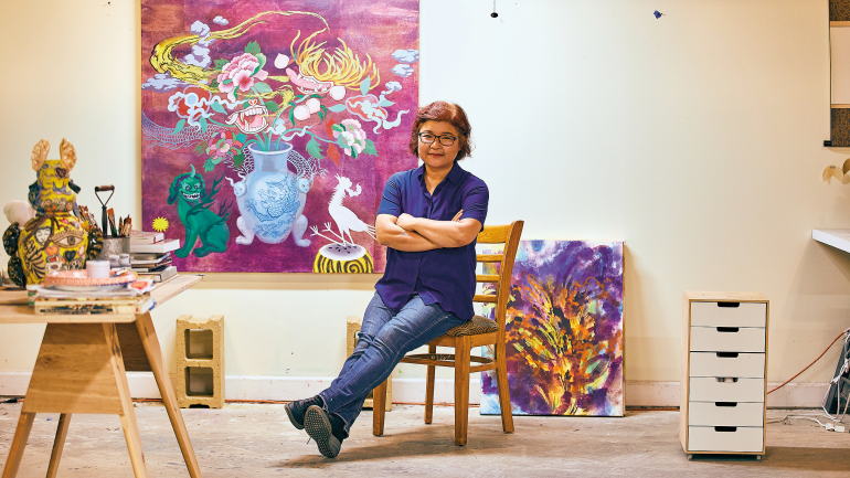 Jiha Moon in her painting studio. For her new still life series, Moon mounted Korean mulberry paper, or hanji, on canvas, then used ink  and acrylic to paint symbolic icons including the peach, peony flowers, and haetae, a Korean mythical creature that protects family and loved ones.