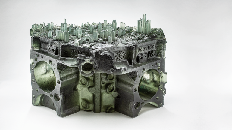 Made from kiln-cast glass, Viviano’s Recasting Detroit, 2021, combines imagery from the city’s manufacturing past and its current urban landscape, 11 x 16.5 x 13.5 in. Photo by Tim Thayer /  RM Hensleigh.