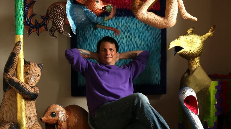 Roberto Benavidez with some of his piñata creations in his Los Angeles home studio. Photo by Roberto Benavidez.