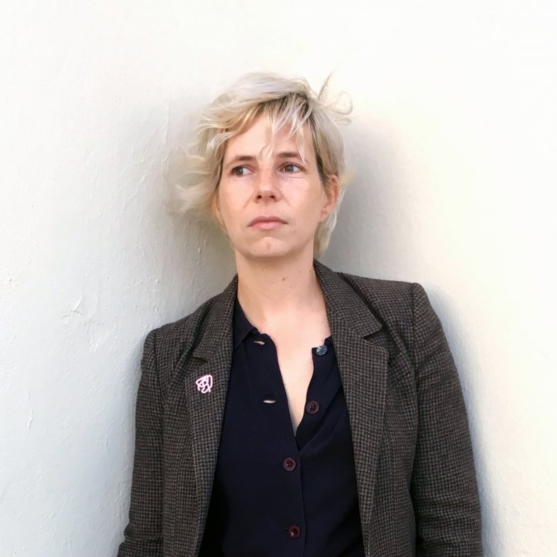 Portrait of Kelly Pendergrast against a white wall