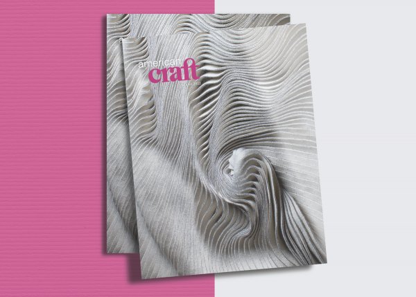 stylized banner graphic featuring a stack of winter 2022 issues of american craft magazine