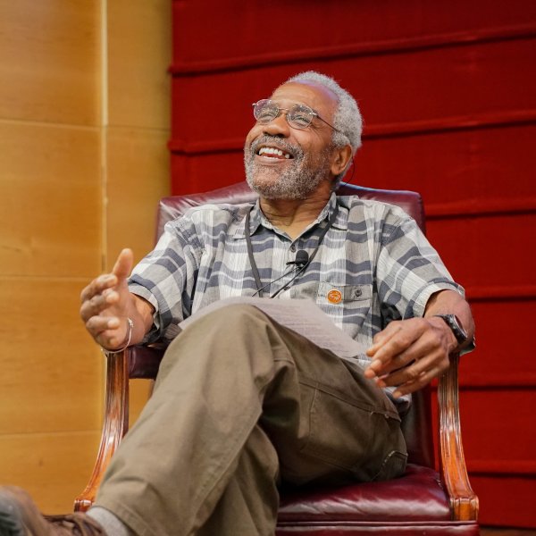 Michael Puryear sits in a chair on a stage.