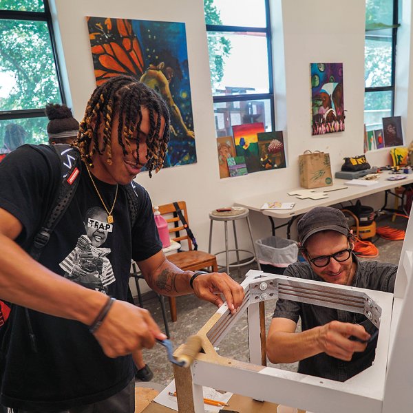 Curt Anderson (left) and furniture designer Peter Scheidt work on a “storytelling chair” at YAYA Arts Center. Photo by La’Shance Perry. 