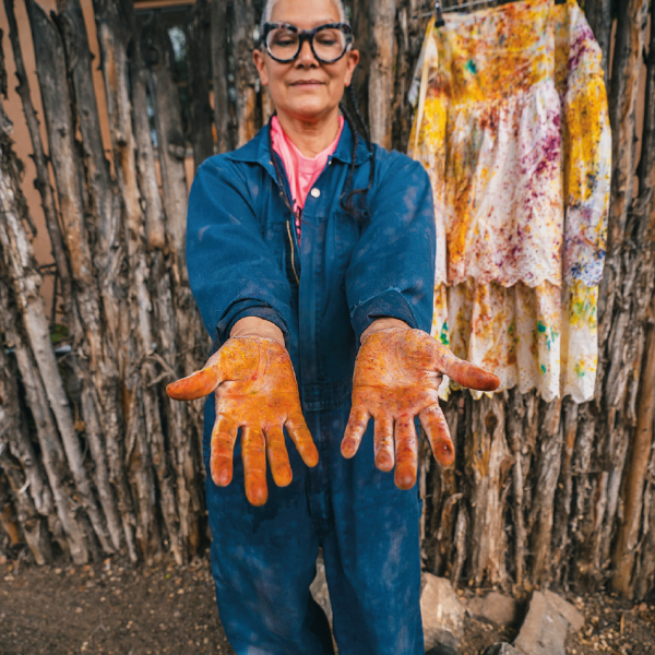Denet Deal’s hands after dyeing clothing outside the store. Photo by Wade Adakai.