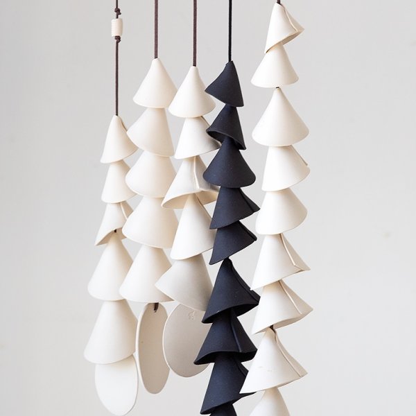  Handmade of bare clay, the conical bells ascend in size, forming a chime.