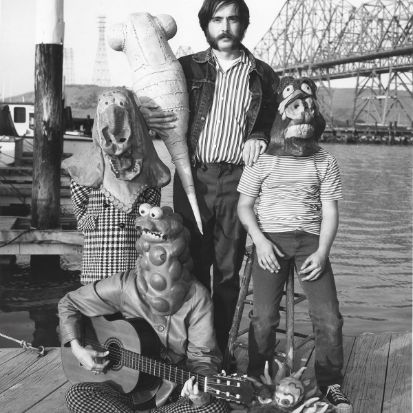 In a photo for the 1969 Objects: USA exhibition, Clayton Bailey (center) holds a polyurethane grub while his family Robin (left), Kurt (right), and Betty (bottom) wear Chicken Mutant and Evil Eye monster masks near their home in Crockett, California.