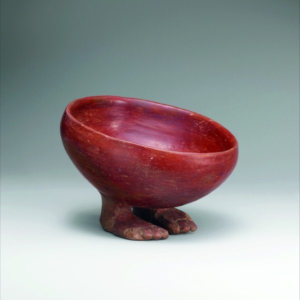 Egyptian bowl with human feet made of red polished ware. 