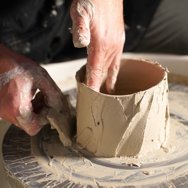 Akira Satake adds dobe (mortar) onto the surface of a chawan, a bowl for sipping tea. Photo by Sayo Harris.
