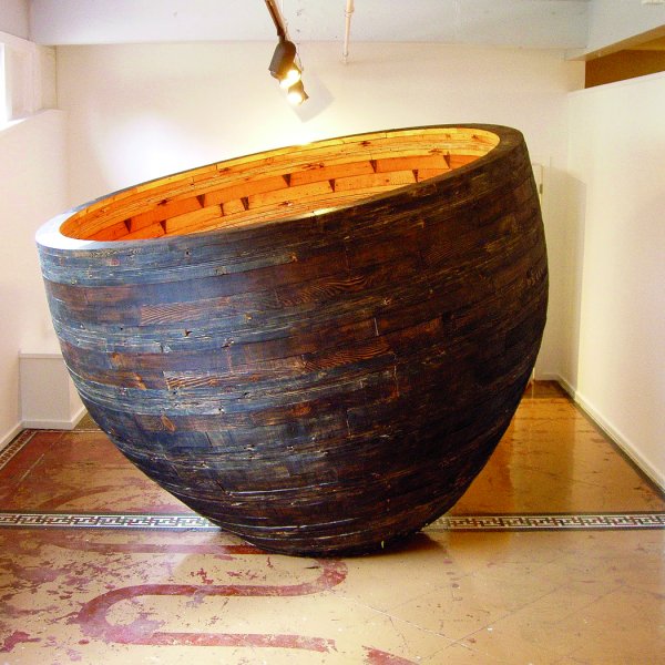 Room sized bowl shaped sculpture made of reclaimed church timbers, carbon, and beeswax.