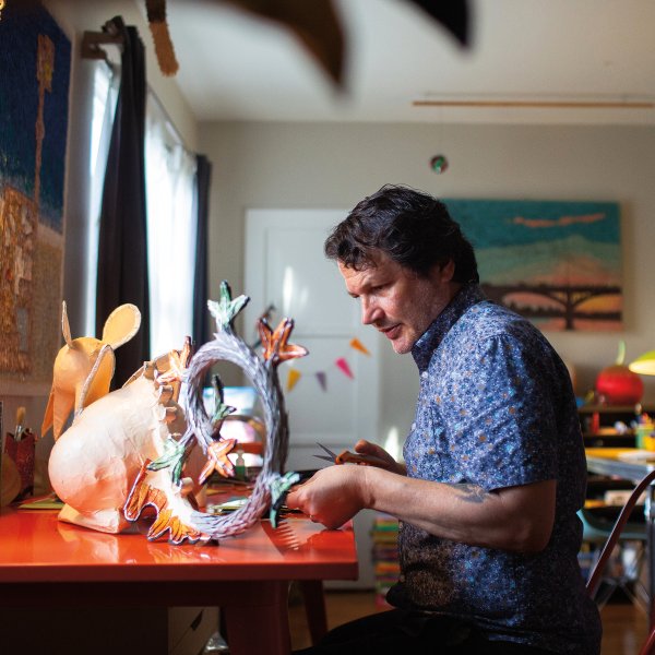 Benavidez works on a commissioned piece from his Illuminated Piñata series, examining the flow of patterns. Photos by James Bernal.