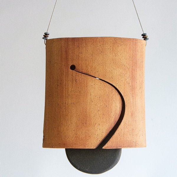 Stoneware clay wind chime in browns and blacks. 