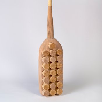 wooden sculpture reminscent of a paddle or brush