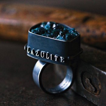 black metal ring with word lazulite and dark blue minerals