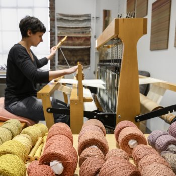 Tali Weinberg weaving with plant- and insect-dyed cotton in her former studio. Photo by Melissa Luckenbaugh.
