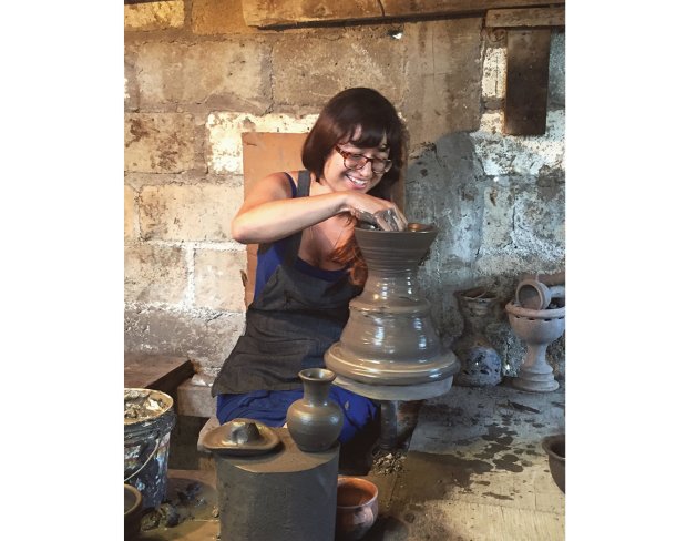 Christina Erives working pottery