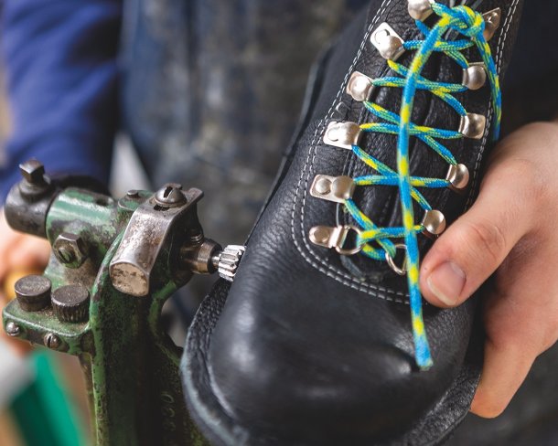 Emmett Moberly-LaChance presses the midsole layer to the upper of the boot.
